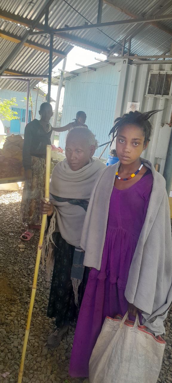 Elder and young girl in community